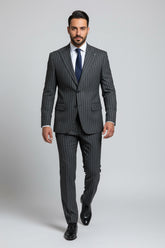 Man wearing charcoal pinstripe two-piece suit with tailored fit and navy tie.